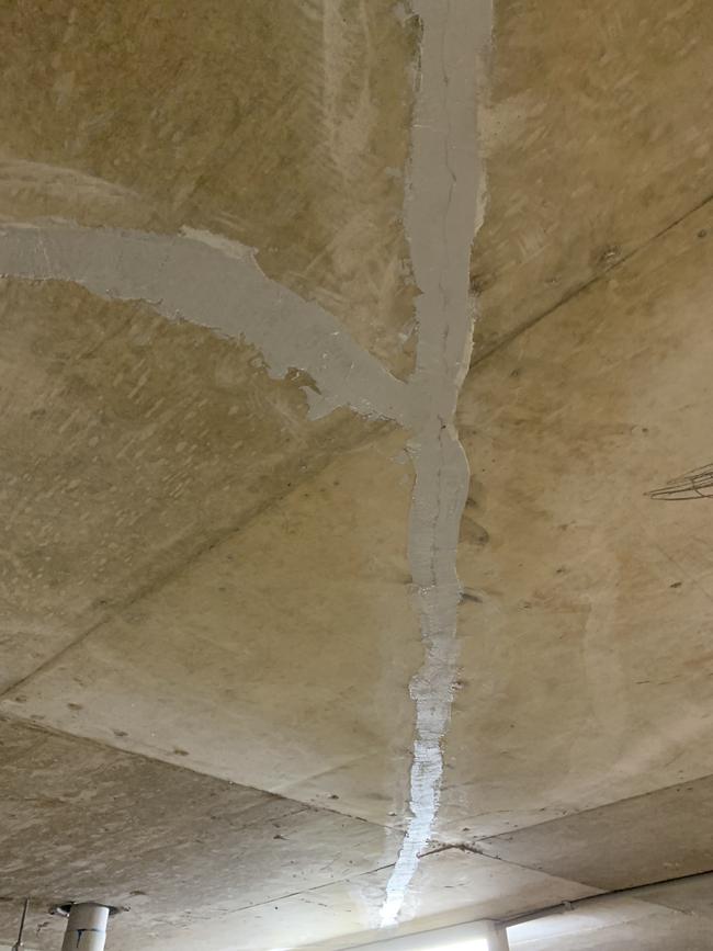 Cracks in the basement carpark ceiling of the Toplace Botony development which has been patched.