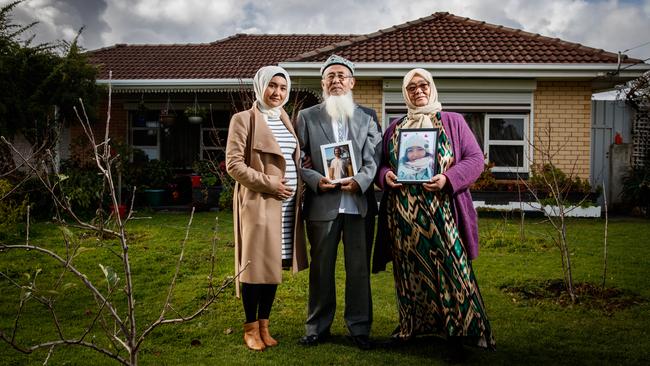 Uyghur family Yakub Sabir and Bahar Mamtimin with their daughter Marhaba Salay. They are holding pictures of their missing daughter, Mahira Yakub, and late son Yalkun Yakub on July 2, 2020 in Adelaide, South Australia. Picture Matt Turner.