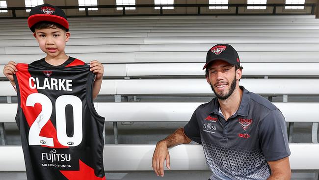 Essendon recruit Zac Clarke is presented with his jumper by fan Eugene 4yrs at their family day Melbourne Showgrounds. Picture: Ian Currie