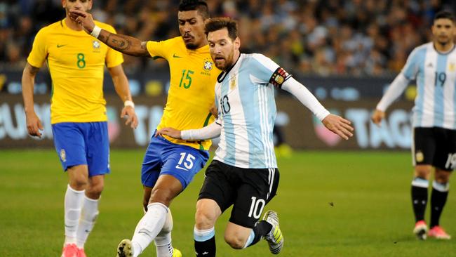 Leo Messi of Argentina is tackled by Maciel Junior of Brazil