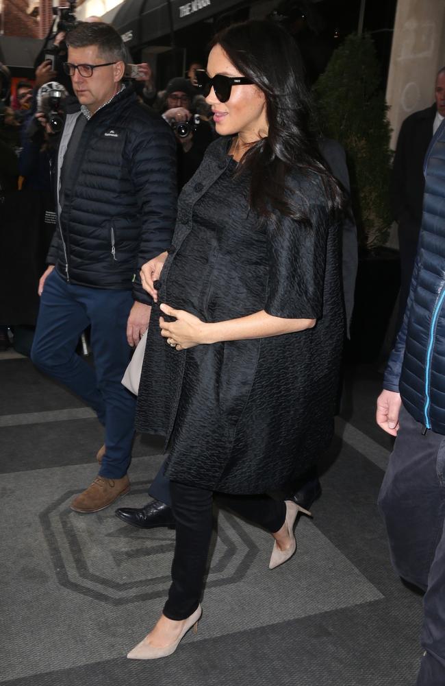 Meghan is surrounded by fans and security as she heads to her car ahead of the event. Picture: BackGrid 