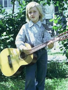 Urban with guitar as a youngster.