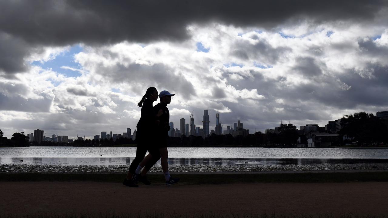 People walking at Albert Park lake in Melbourne. Picture: William West/AFP