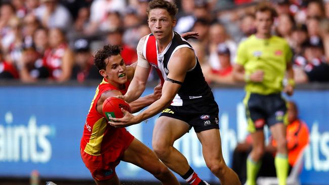 Jack Billings dashes past Gold Coast Suns midfielder Wil Powell in Round 1. Picture: Dylan Burns/AFL Photos. 