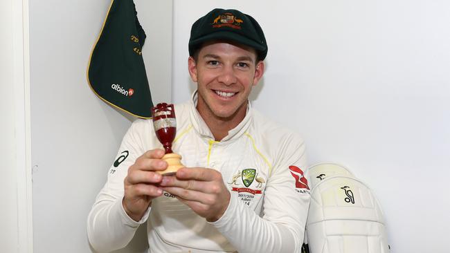 Tim Paine celebrates in the dressing room after Australia secured the Ashes on Monday.