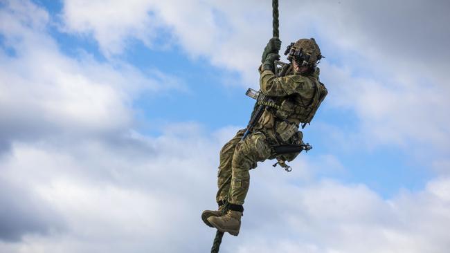 An Australian Army special forces soldier conducts a fast-rope descent from an Army MRH-90 Taipan helicopter. Picture: ADF