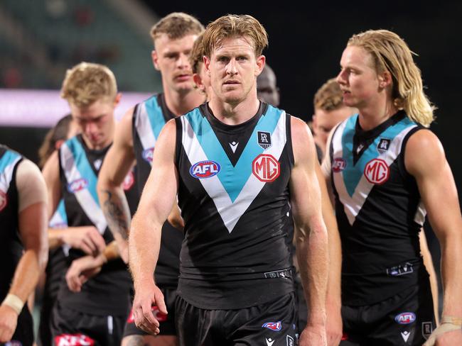 ADELAIDE, AUSTRALIA - MAY 15: Tom Jonas of the Power leads his team mates from the ground after the final siren during the round 9 AFL match between the Port Adelaide Power and the Western Bulldogs at Adelaide Oval on May 15, 2021 in Adelaide, Australia. (Photo by Daniel Kalisz/Getty Images)