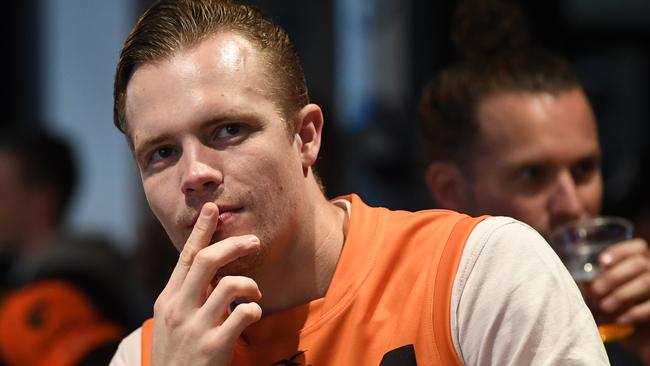 A dejected GWS fan watches on during a disastrous grand final.