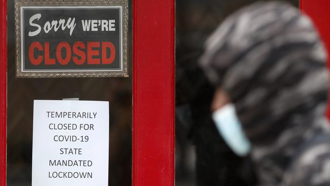 A pedestrian walks by a store closed due to the COVID-19 pandemic in Grosse Pointe, Michigan. Picture: AP