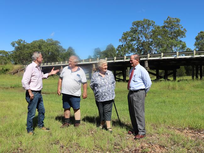 Chris Gulaptis is joined by Clarence Valley Mayor Jim Simmons (far right) and local residents Peter Williamson & ‘Teddy’ Bowles to welcome the announcement of repair of 31 timber bridges in the Clarence Valley, including two on the entrance to Coutts Crossing behind. Photo: Debbie Newton