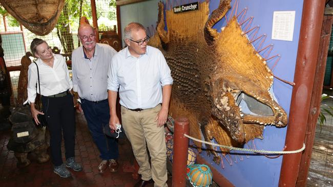 Federal Environment Minister Sussan Ley, Member for Leichhardt Warren Entsch and Prime Minister Scott Morrison look at the skinned remains of a saltwater crocodile called Bone Cruncher at Marineland Crocodile Park on Green Island, off the coast of Cairns. Warren Entsch caught the crocodile off Cooktown in his previous job as a croc hunter. Picture: Brendan Radke