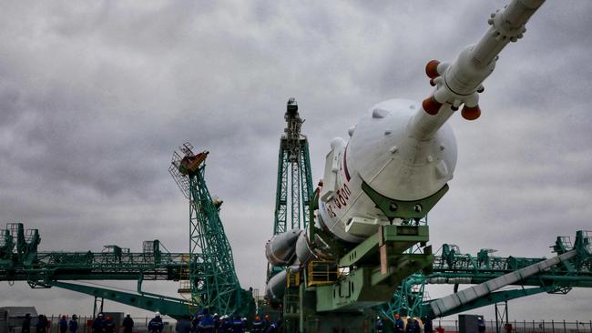 The Soyuz-2.1a rocket booster with the Soyuz MS-21 spacecraft is lifted to the launch pad at the Russian-leased Baikonur cosmodrome in Kazakhstan on March 15, 2022. It took a Russian crew to the International Space Station. (Photo by Handout / Russian Space Agency Roscosmos / AFP)