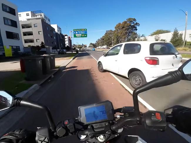 The white Toyota hatchback turned from the middle lane colliding with the motorcycle at more than 75km/h. Picture: Facebook / Dash Cam Owners Australia