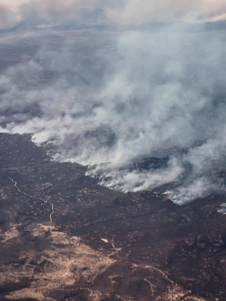 Maegan Brown took this shot of bushfire-ravaged Queensland on a flight back from Melbourne. Picture: @maegan_kb