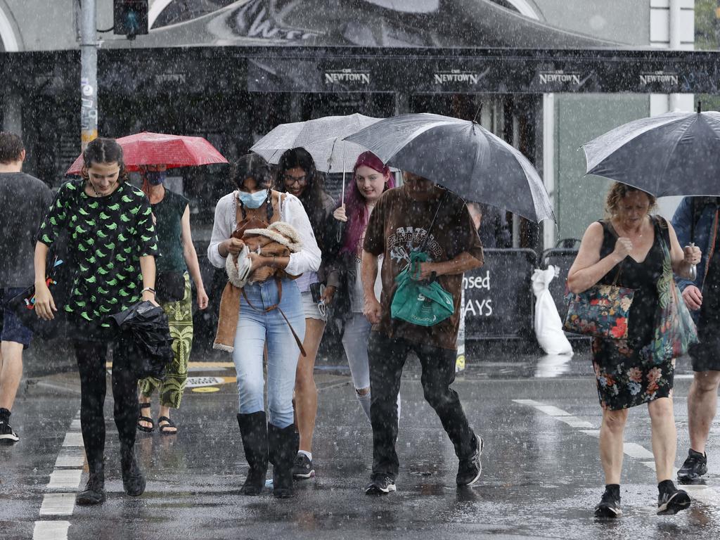 People walking in the rain in Newtown on Saturday. Picture: Tim Hunter