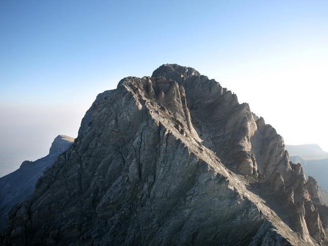 "Summit of Mount Olympus from Mount Skala. Mount Olympus is highest mountain in Greece at 2917 meters. Peak name is Mytikas. Mount Olympus is the home of the Twelve Olympians, the principal gods in the Greek pantheon."