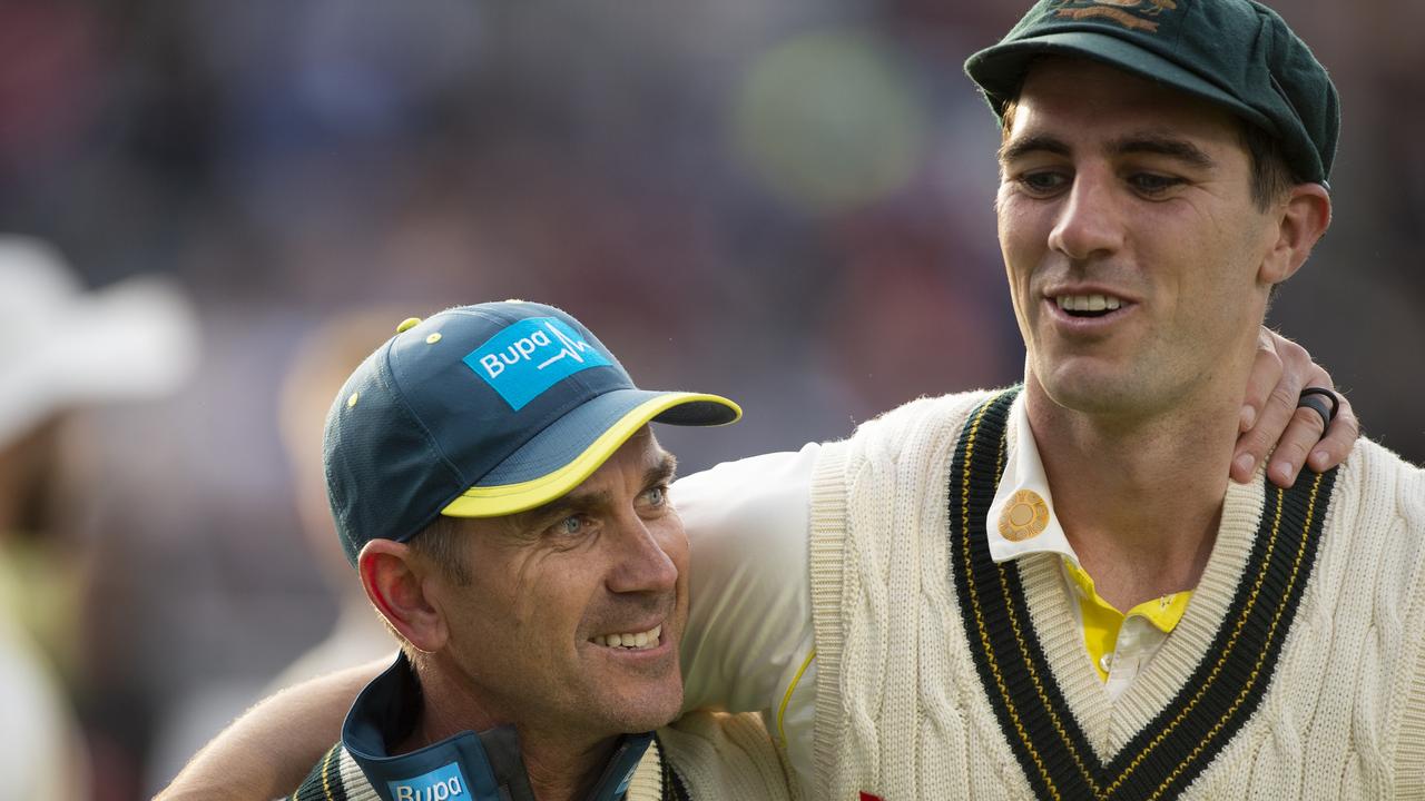 Australia Coach Justin Langer celebrates with bowler Pat Cummins