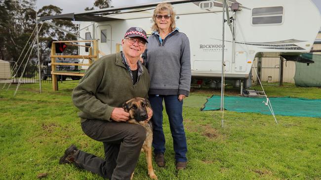 Buchan resident Bob Carney with his dog Zena, and the caravan he and his wife Linda are living in after losing their home to the fires in January. Picture: Alex Coppel