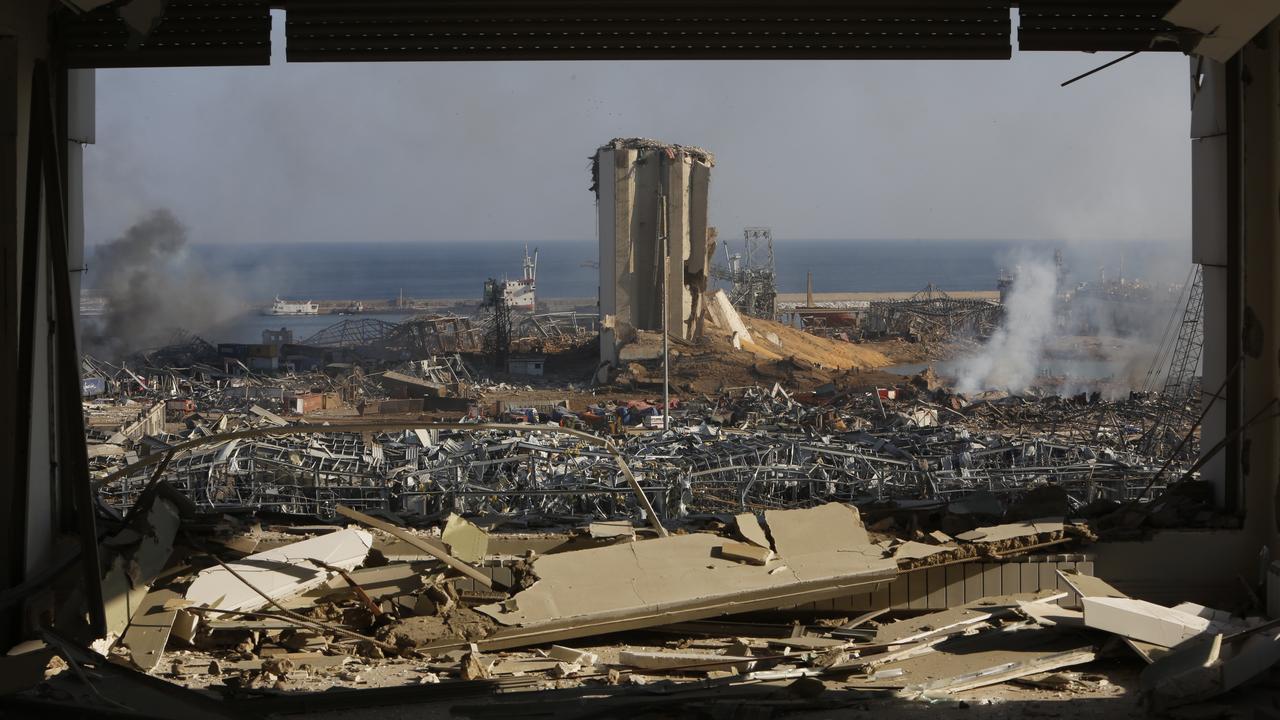 Smoke rises above wrecked buildings at the city's port. Picture: Getty Images