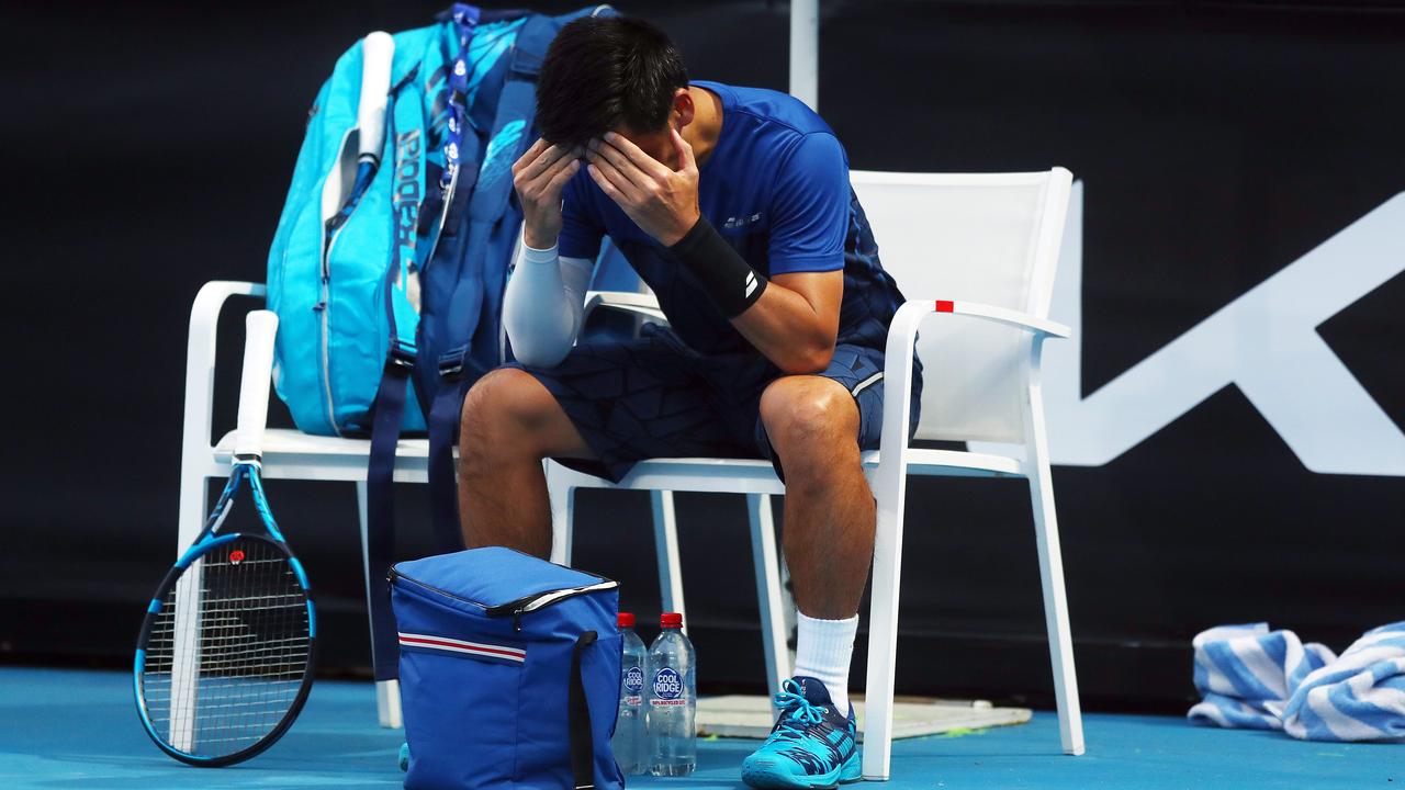 Tomic’s opponent, Yuichi Sugita of Japan, was inconsolable after choosing to withdraw from the match. Picture: Getty Images