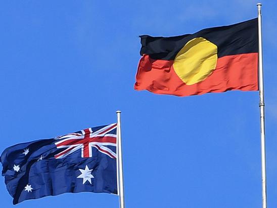 The Australian national flag flies alongside the Aboriginal flag atop the Sydney Harbour Bridge on May 26, 2020 in Sydney, Australia.
