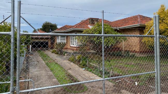 The state opposition has identified several empty fenced-off homes on the same street at Clovelly Park. Picture: Supplied