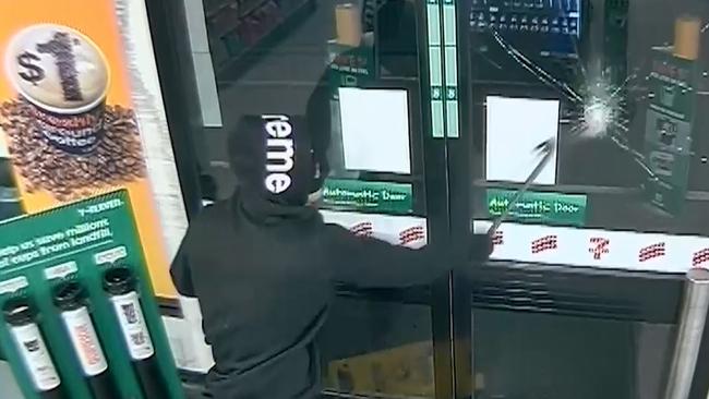 The man smashes a door on his way out of the service station.