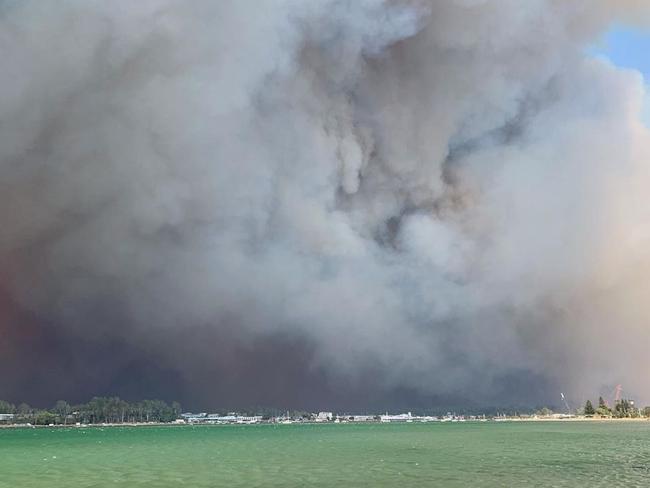 Residents watch on as town burns. Picture: Jessica Ford