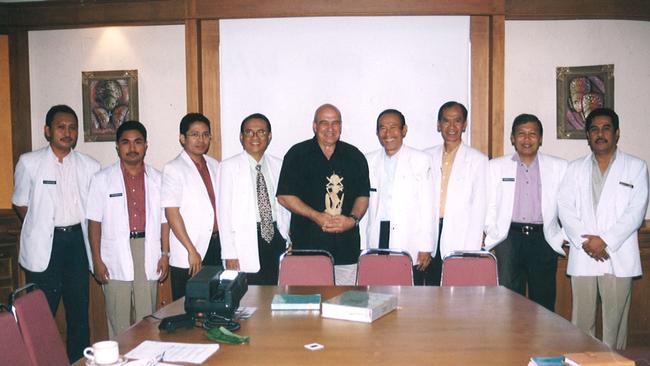 Associate Professor John Svigos, with staff at Sanglah Hospital in Bali during a 2014 visit.