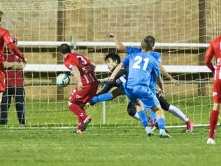 OPENING GOAL: South West Queensland Thunder striker Travis Cooper (obscured) scores against Olympic FC at Toowoomba's Clive Berghofer Stadium. Picture: Nev Madsen