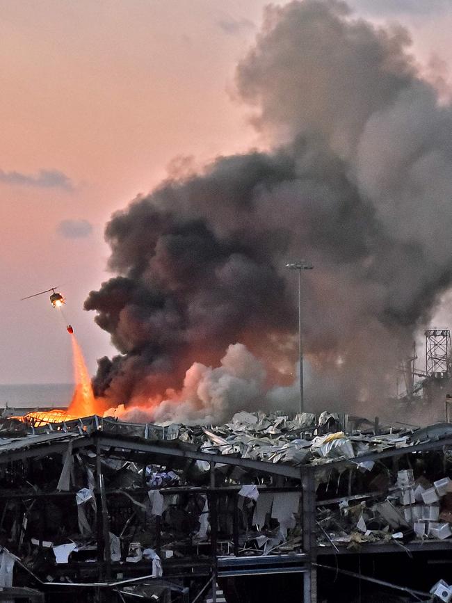 A helicopter puts out a fire after the explosions hit Beirut. Picture: STR/AFP