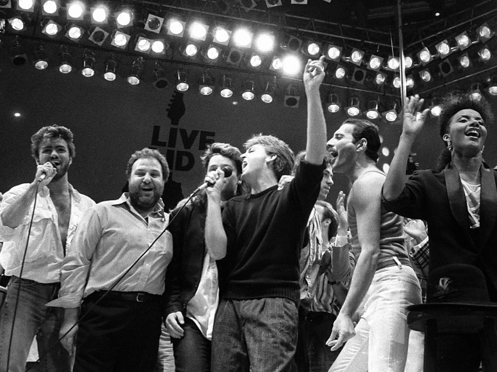 July 13, 1985, from left, George Michael of Wham!, concert promoter Harvey Goldsmith, Bono of U2, Paul McCartney, concert organizer Bob Geldof and Freddie Mercury of Queen join in the finale of the Live Aid famine relief concert, at Wembley Stadium, London.Picture: AP Photo/Joe Schaber