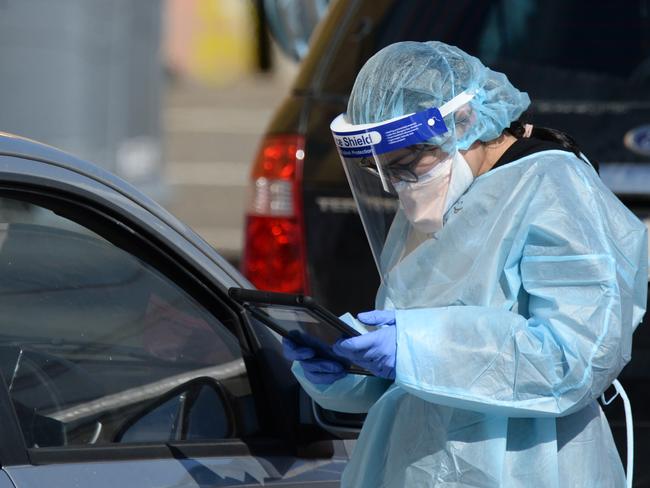 MELBOURNE, AUSTRALIA - NewsWire Photos AUGUST 23, 2021: Medical staff attend to people queueing at the COVID testing station next to the Palais Theatre at St Kilda. Picture: NCA NewsWire / Andrew Henshaw