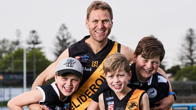 Kane Cornes with his sons, Raph, 11, Sonny, 9 and Eddy, 13 at Glenelg Football Club, ahead of the grand-final on Sunday. Picture: Matt Loxton