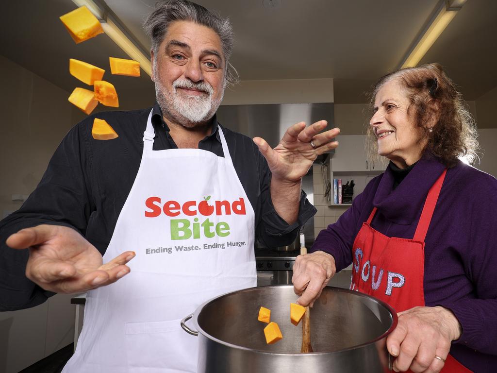 Matt Preston with Christ Church Community Centre volunteer Josie Alexander during Coles SecondBite Winter Appeal launch at Christ Church Community Centre in St Kilda, Melbourne. Picture: Martin Keep/Coles