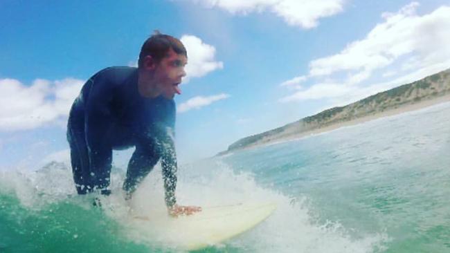 Central District footballer Jez McLennan in the surf.