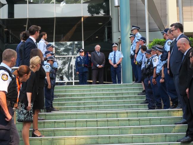 Police and curt staff form a guard of honour as prosecutor Sergeant Richard Taylor is piped out of Gosford Court for the last time. Picture: Richard Noone