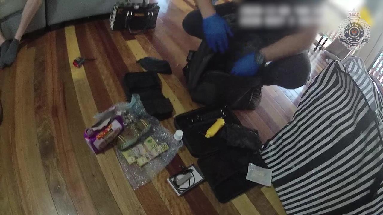 An officer discovers the wads of cash and drugs allegedly found in the home of a man in South Rochedale.