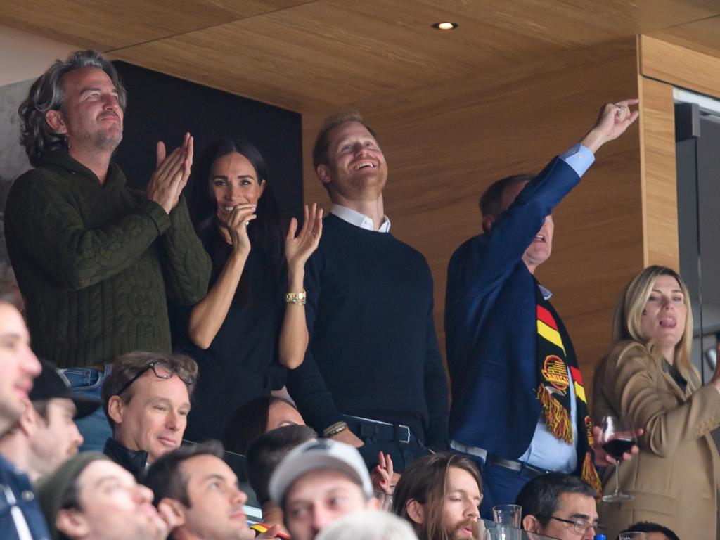 Prince Harry and Meghan Markle celebrate a Vancouver Canucks goal during the third period of the NHL game against the San Jose Sharks at Rogers Arena. Picture: Getty Images