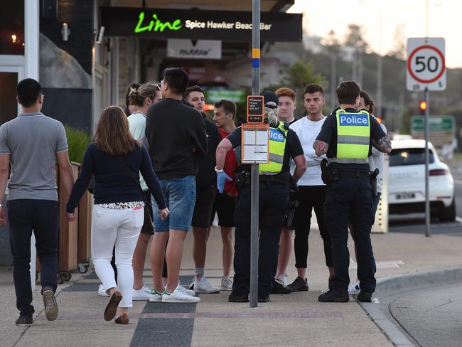 Police talk with a group of schoolies in Rye. Picture: Josie Hayden