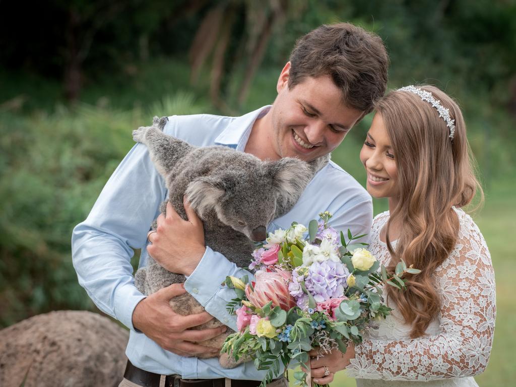 Chandler Powell and Bindi Irwin on their wedding day with a koala close up. Picture: Kate Berry