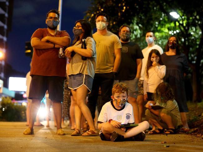 Cody Brady, 7, plays video games while waiting in line with his mother Kellie Brady. Picture: David Clark