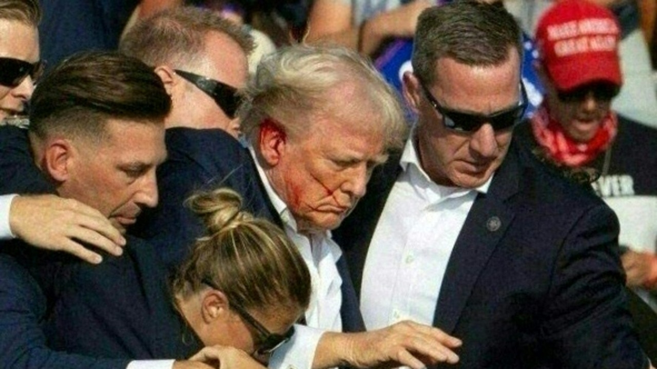 Donald Trump surrounded by Secret Service agents after he was shot. Picture: Rebecca Droke / AFP