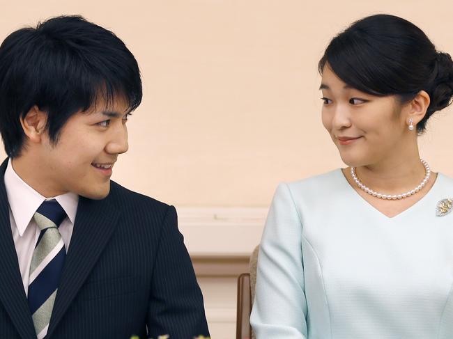 Japan's Princess Mako, right, the elder daughter of Prince Akishino and Princess Kiko, and her fiance Kei Komuro, look at each other during a press conference at Akasaka East Residence in Tokyo, Sunday, Sept. 3, 2017. Japanese Emperor Akihito's oldest grandchild, Princess Mako, says she is getting married to her university classmate who won her heart with bright smiles and sincerity.(AP Photo/Shizuo Kambayashi, Pool)