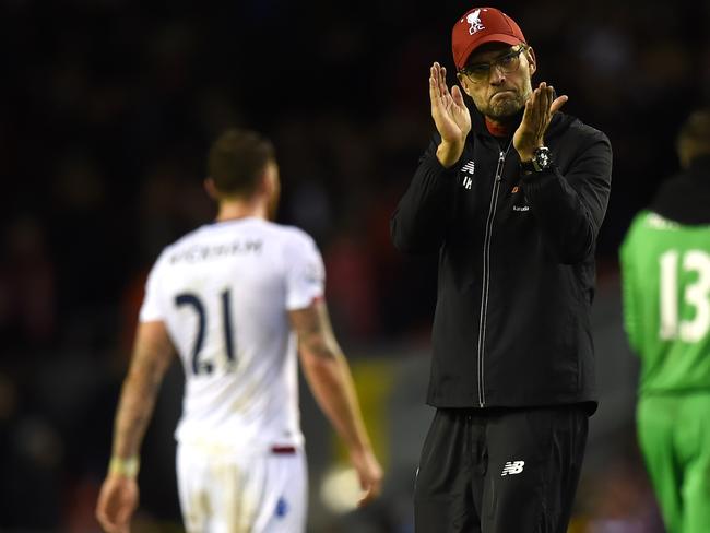 Liverpool's German manager Jurgen Klopp (C) applauds the fans.