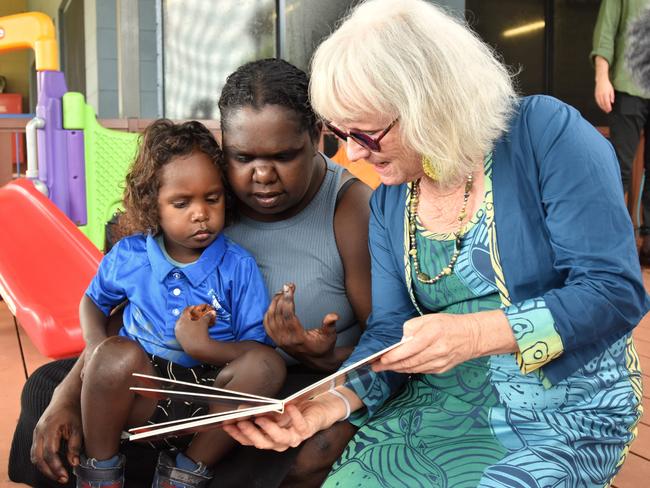 Gunbalanya School's first Families as First Teachers Educator Nuala Scannell works through conversational reading exercises with a parent and child as part of the FAFT program. Picture: Sierra Haigh