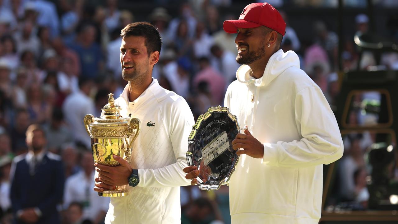 Novak Djokovic holds the winner’s trophy and Nick Kyrgios holds the runners-up trophy after the Wimbledon men’s final at the All England Club on July 10, 2022. Picture: Getty Images
