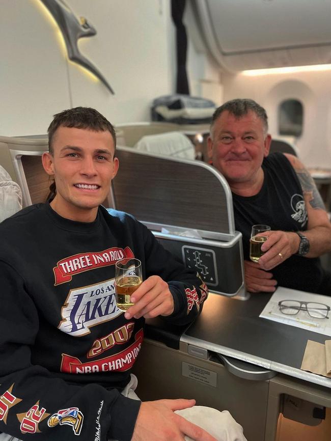 Harry Garside with his father in business class on the way back from South Africa. Photo: Instagram.