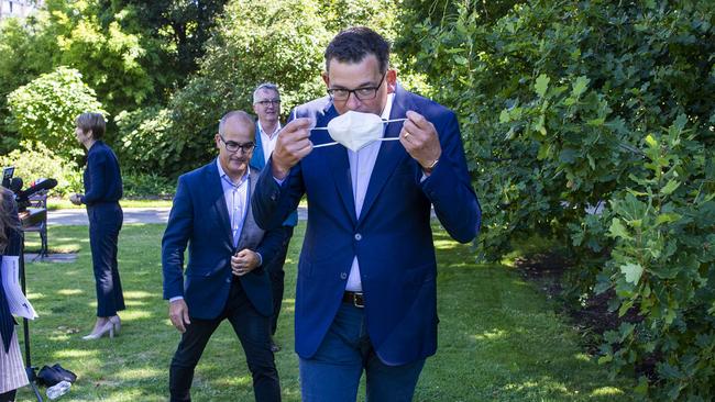 Victorian Premier Daniel Andrews puts on a mask after a press conference with Deputy Premier, James Merlino and Minister for Health, Martin Foley in February last year. Picture: NCA NewsWire / Aaron Francis