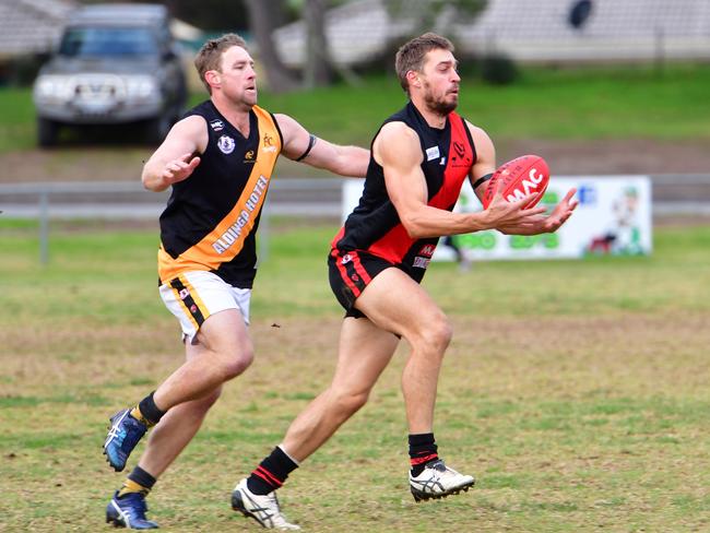 Corey Mathewson (A) and Denis Iljcesen (MV) - Southern Football League A Grade - Morphett Vale (red) v Aldinga (Gold) at Morphette Vale, Adelaide on Saturday, July 15, 2017.  (AAP Image/ Keryn Stevens)